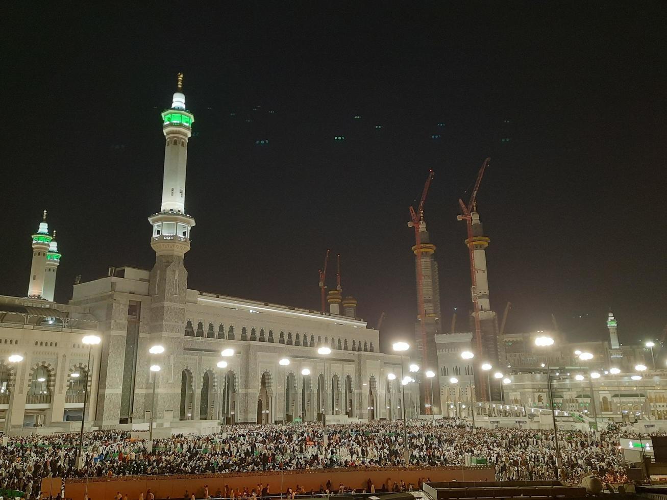 Mecca, Saudi Arabia, April 2023 - A beautiful view of pilgrims, tall buildings and lights at night on the outer road in Masjid al-Haram, Mecca. photo