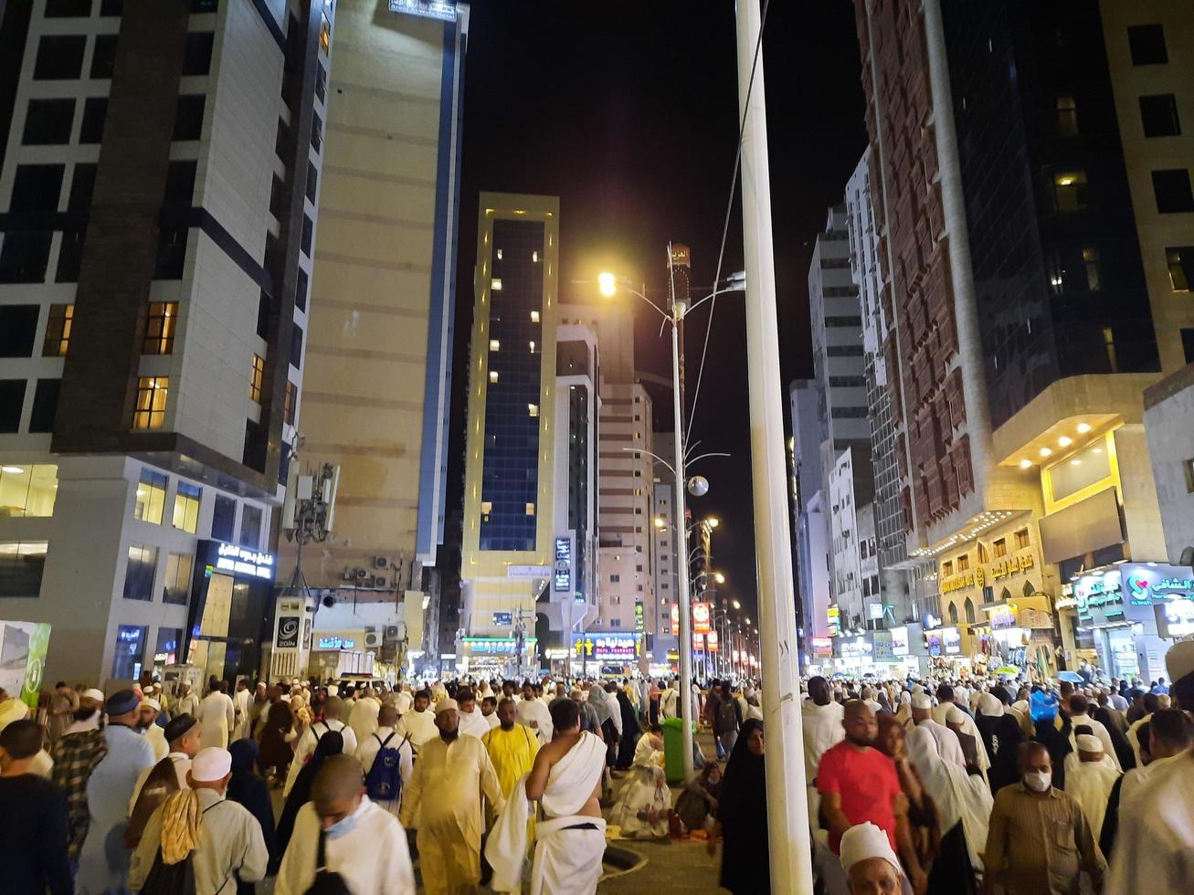 Mecca, Saudi Arabia, April 2023 - A beautiful view of pilgrims, tall buildings and lights at night on the outer road in Masjid al-Haram, Mecca. photo