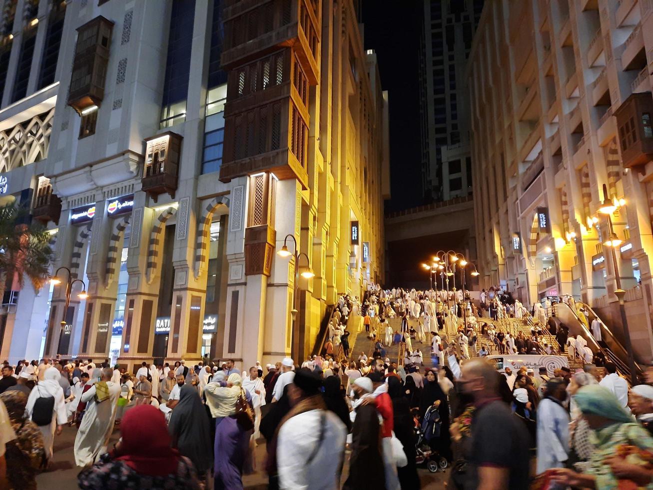 Mecca, Saudi Arabia, April 2023 - A beautiful view of pilgrims, tall buildings and lights at night on the outer road in Masjid al-Haram, Mecca. photo