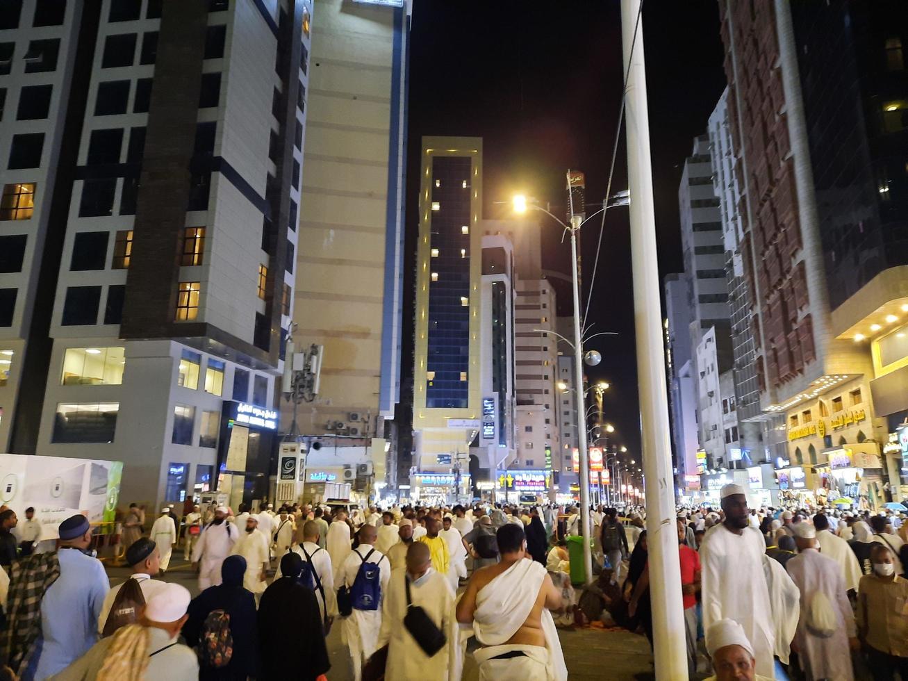 Mecca, Saudi Arabia, April 2023 - A beautiful view of pilgrims, tall buildings and lights at night on the outer road in Masjid al-Haram, Mecca. photo