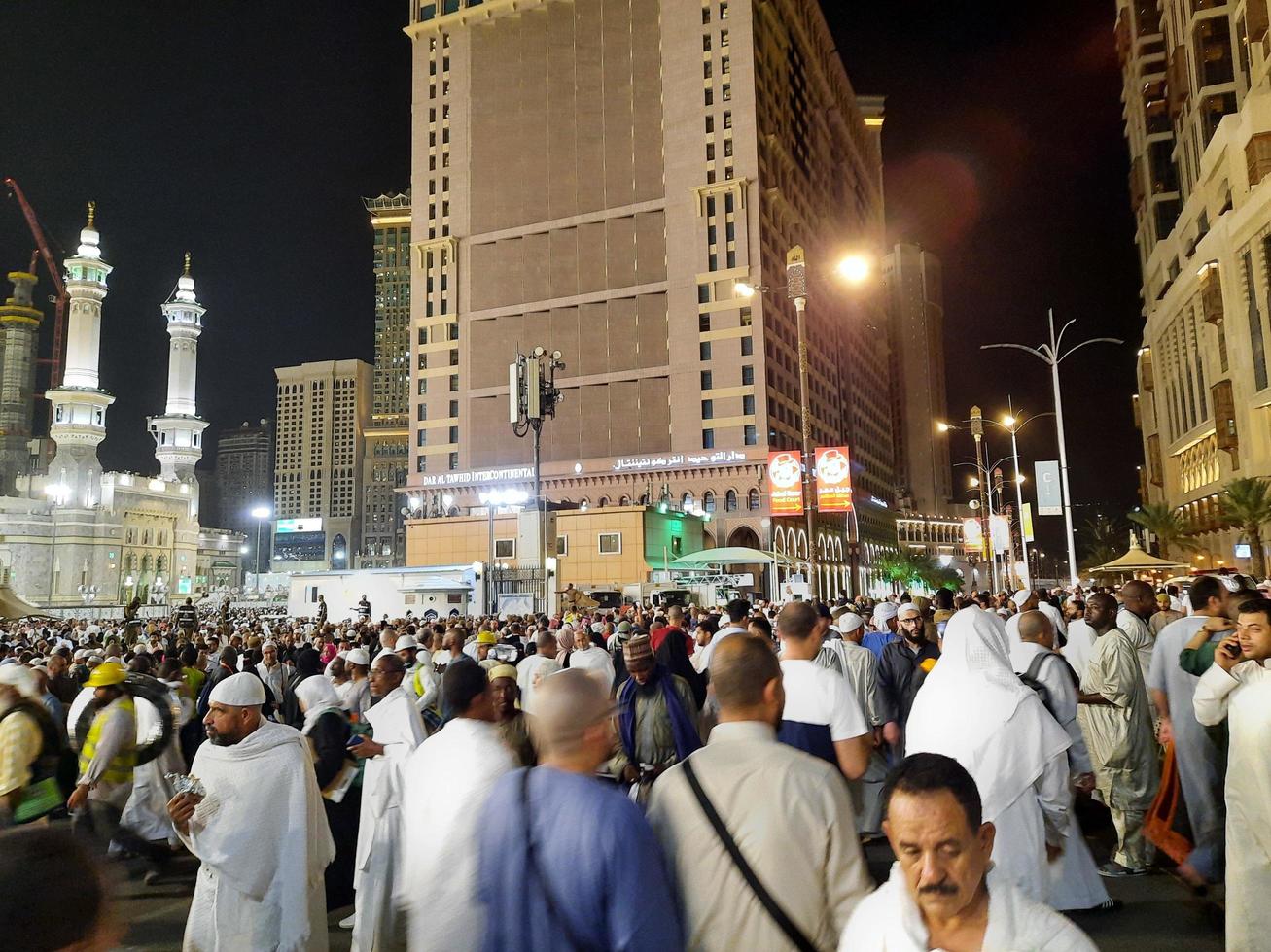 Mecca, Saudi Arabia, April 2023 - A beautiful view of pilgrims, tall buildings and lights at night on the outer road in Masjid al-Haram, Mecca. photo