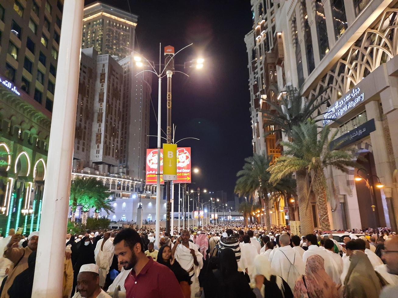 Mecca, Saudi Arabia, April 2023 - A beautiful view of pilgrims, tall buildings and lights at night on the outer road in Masjid al-Haram, Mecca. photo