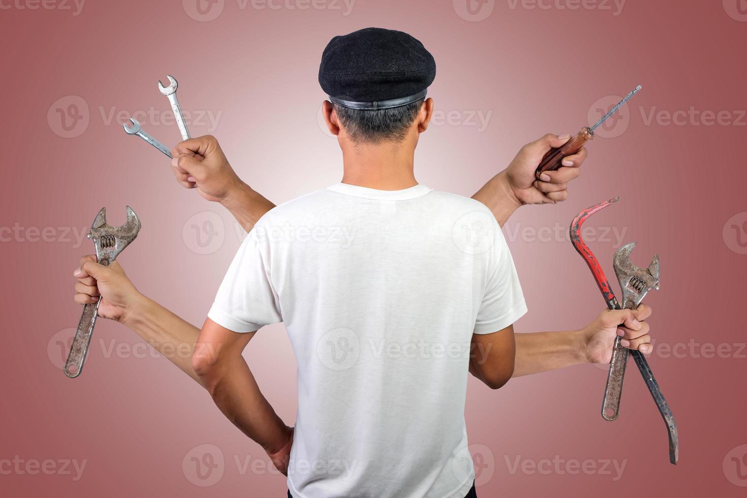 Male worker with multiple hands holding different carpentry tools. International labor day concept photo