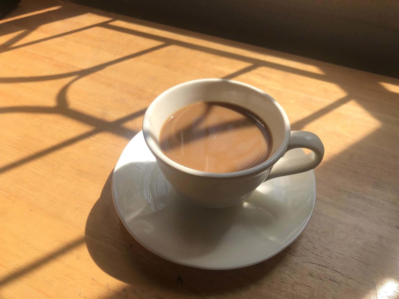 Hot coffee cup on table photo