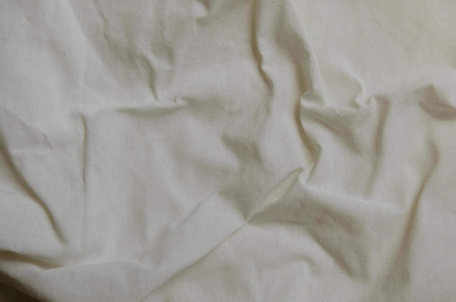 Texture of Crumpled White Calico Fabric photo