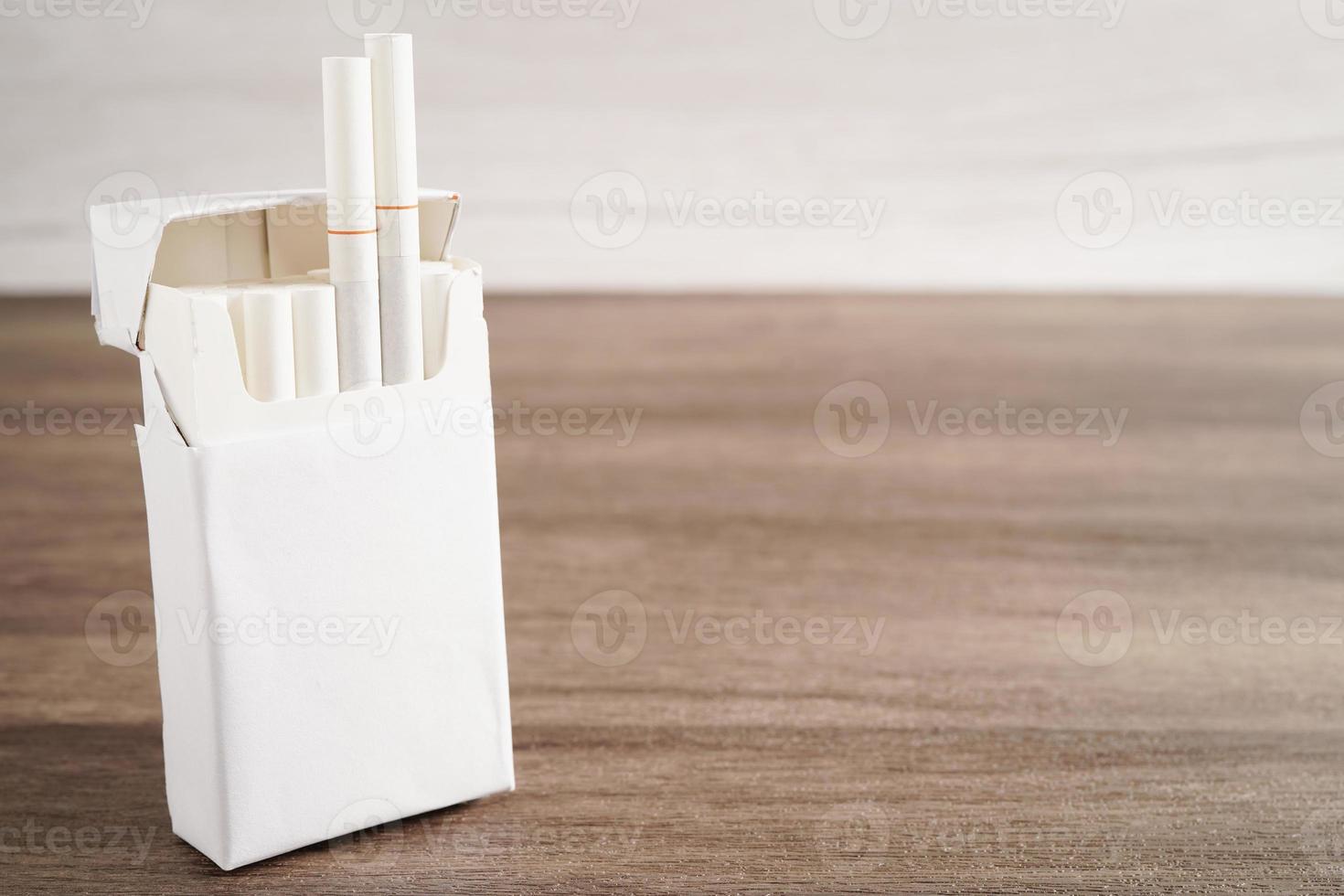 Cigarette in pack, roll tobacco in paper with filter tube, No smoking concept. photo