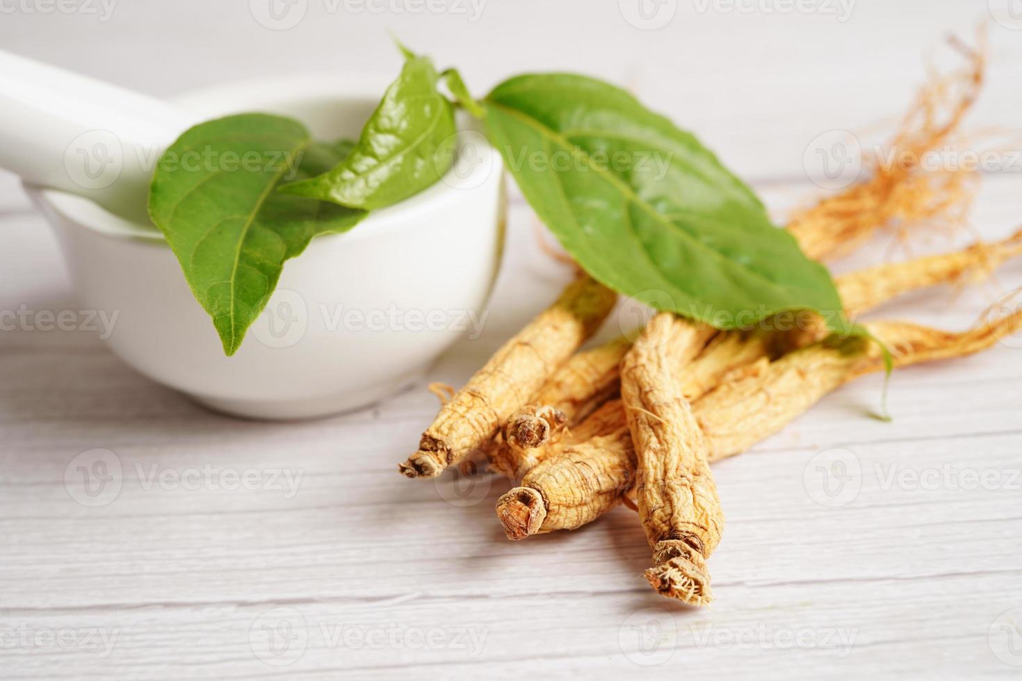 Ginseng roots and green leaf, healthy food. photo