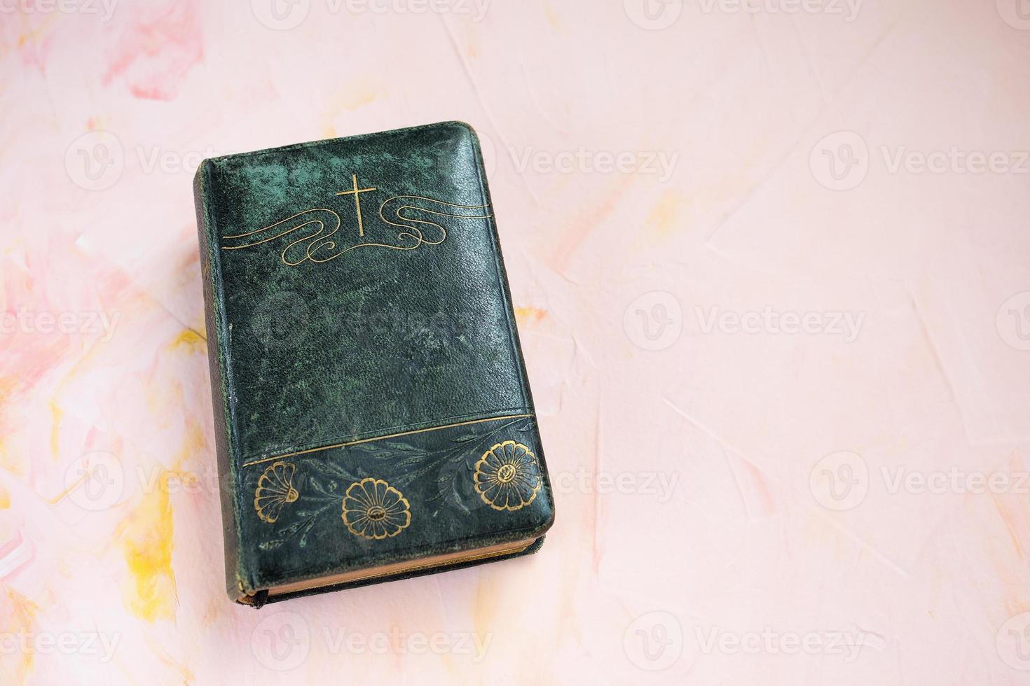 Bible or poetry book on pink, christian background photo