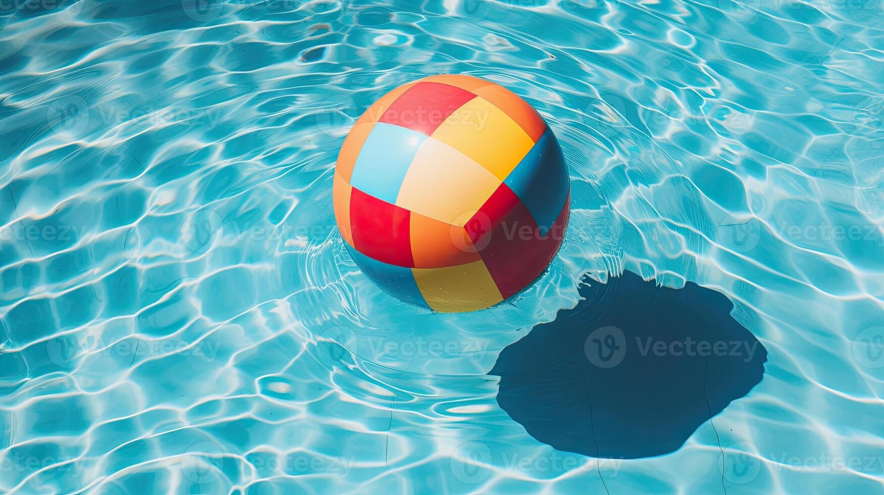 A beach ball floating in a pool. photo