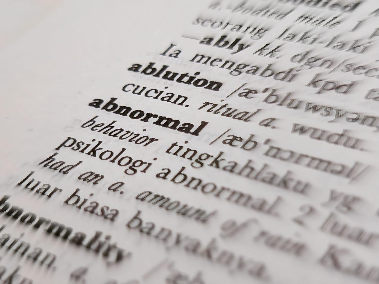 a close up of the word abnormal in the English to Indonesian dictionary. For word background or wallpaper photo