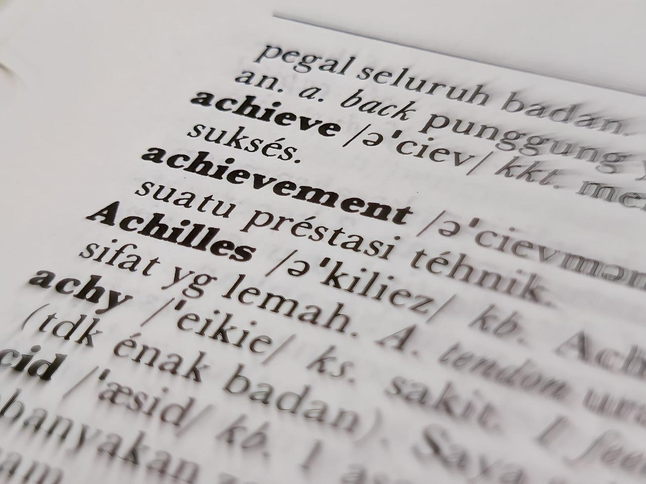 a close up of the word achievement in the English to Indonesian dictionary. For language background or wallpaper photo