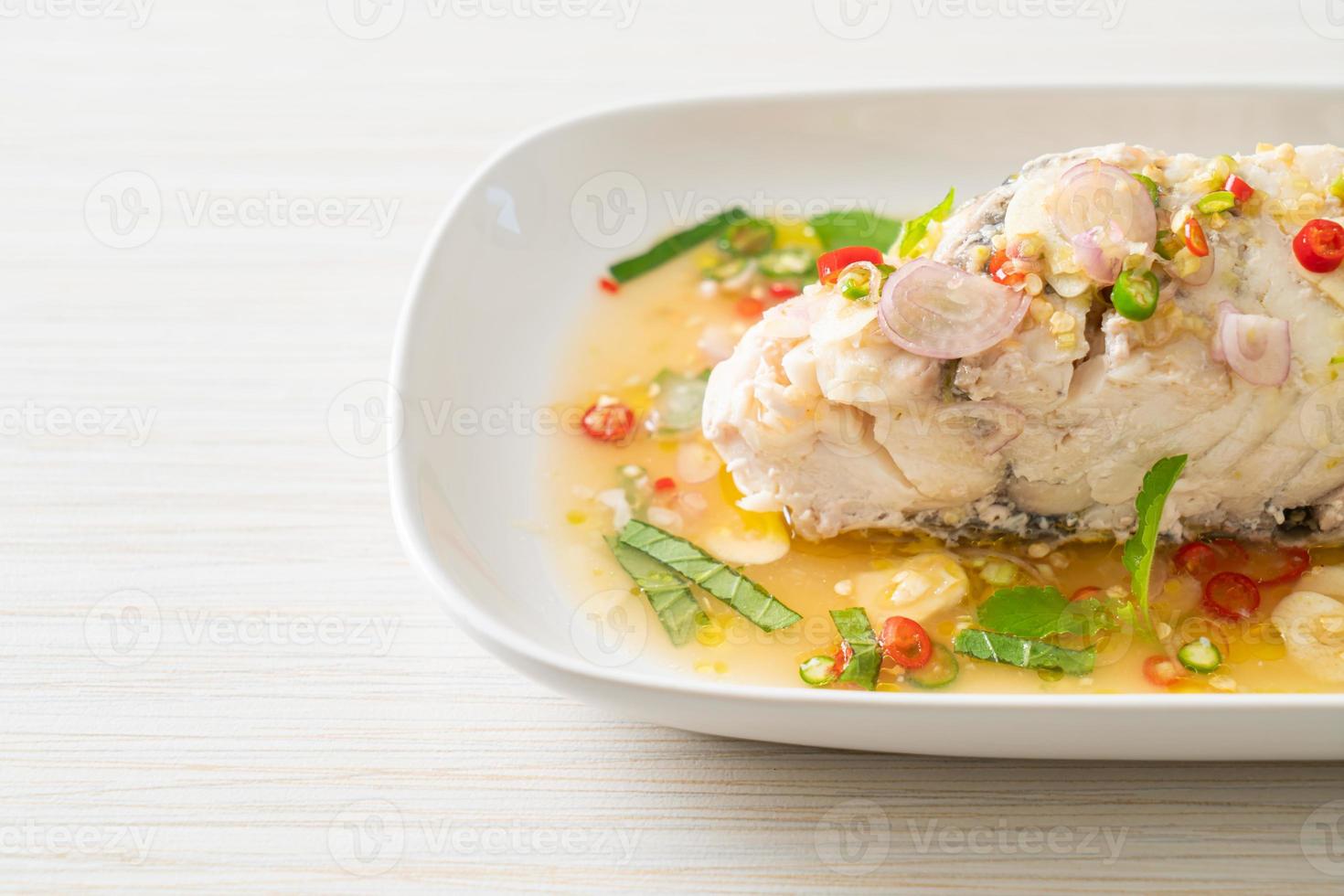 steamed sea bass fish with herbs 22977475 Stock Photo at Vecteezy