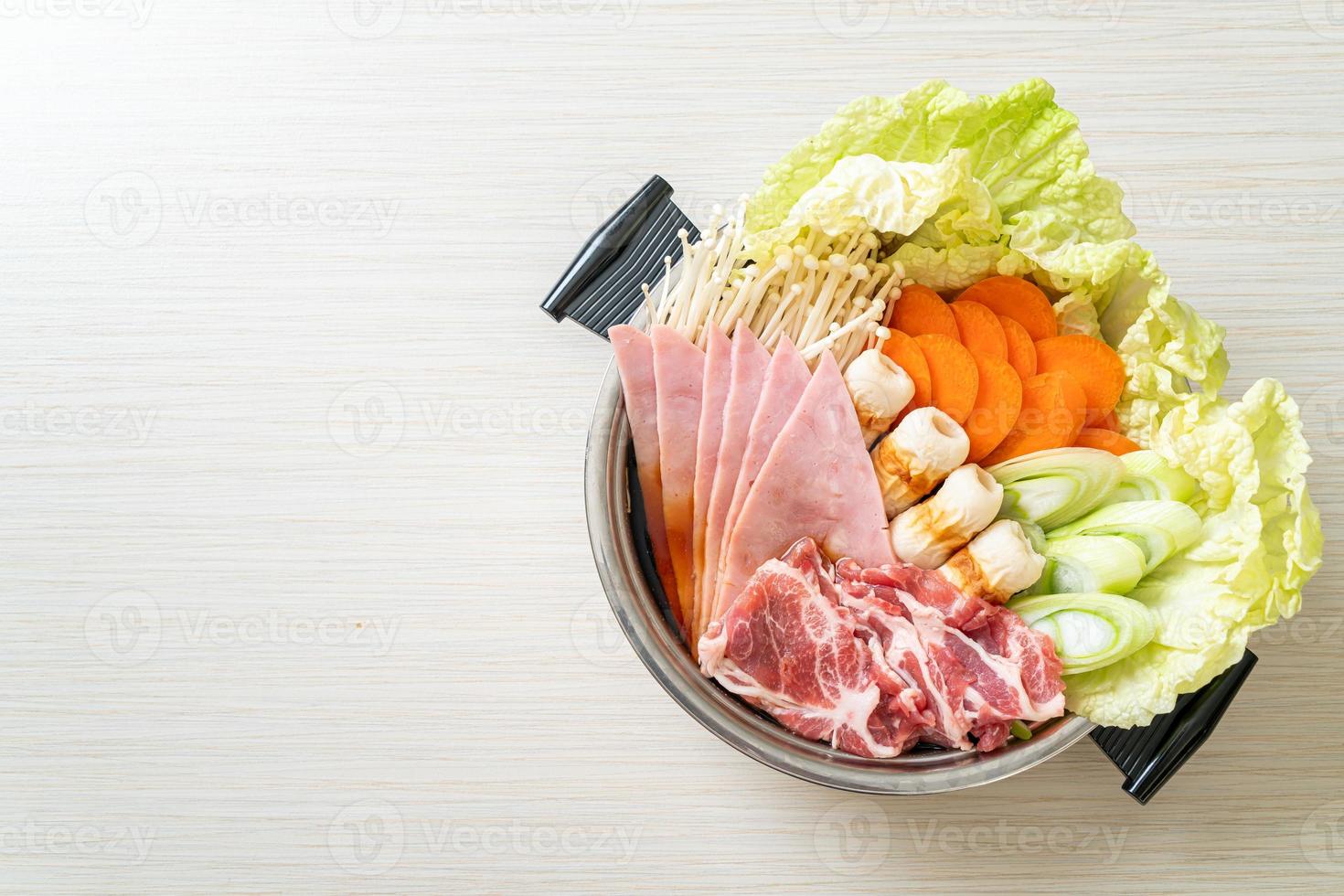 sukiyaki or shabu hot pot black soup with meat raw and vegetable photo