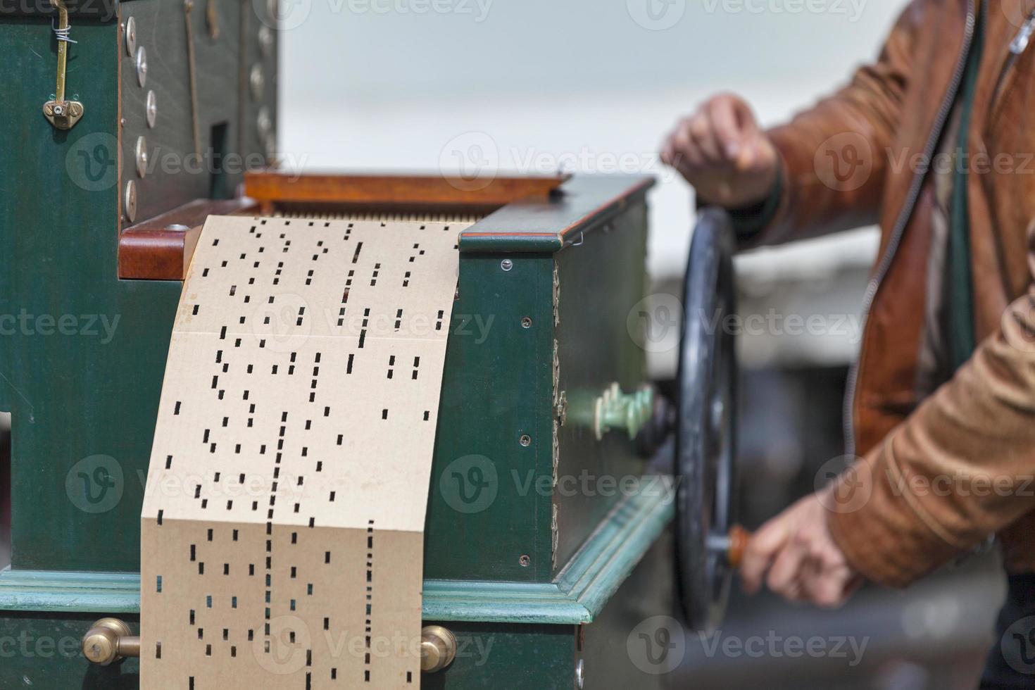 Man playing with a barrel organ photo