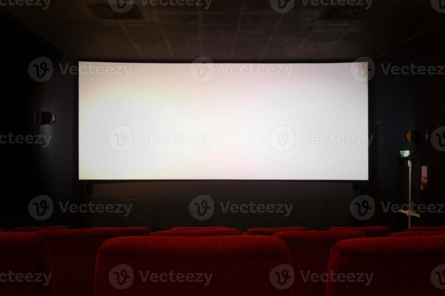 Empty movie theater with blank screen photo