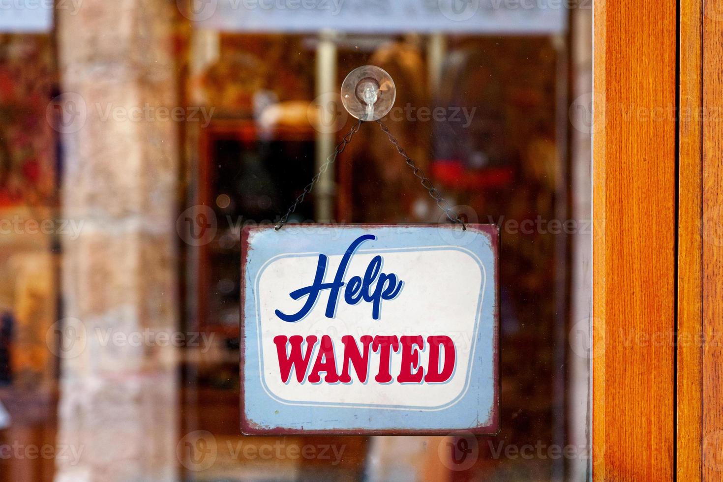 Help wanted sign in a store window photo