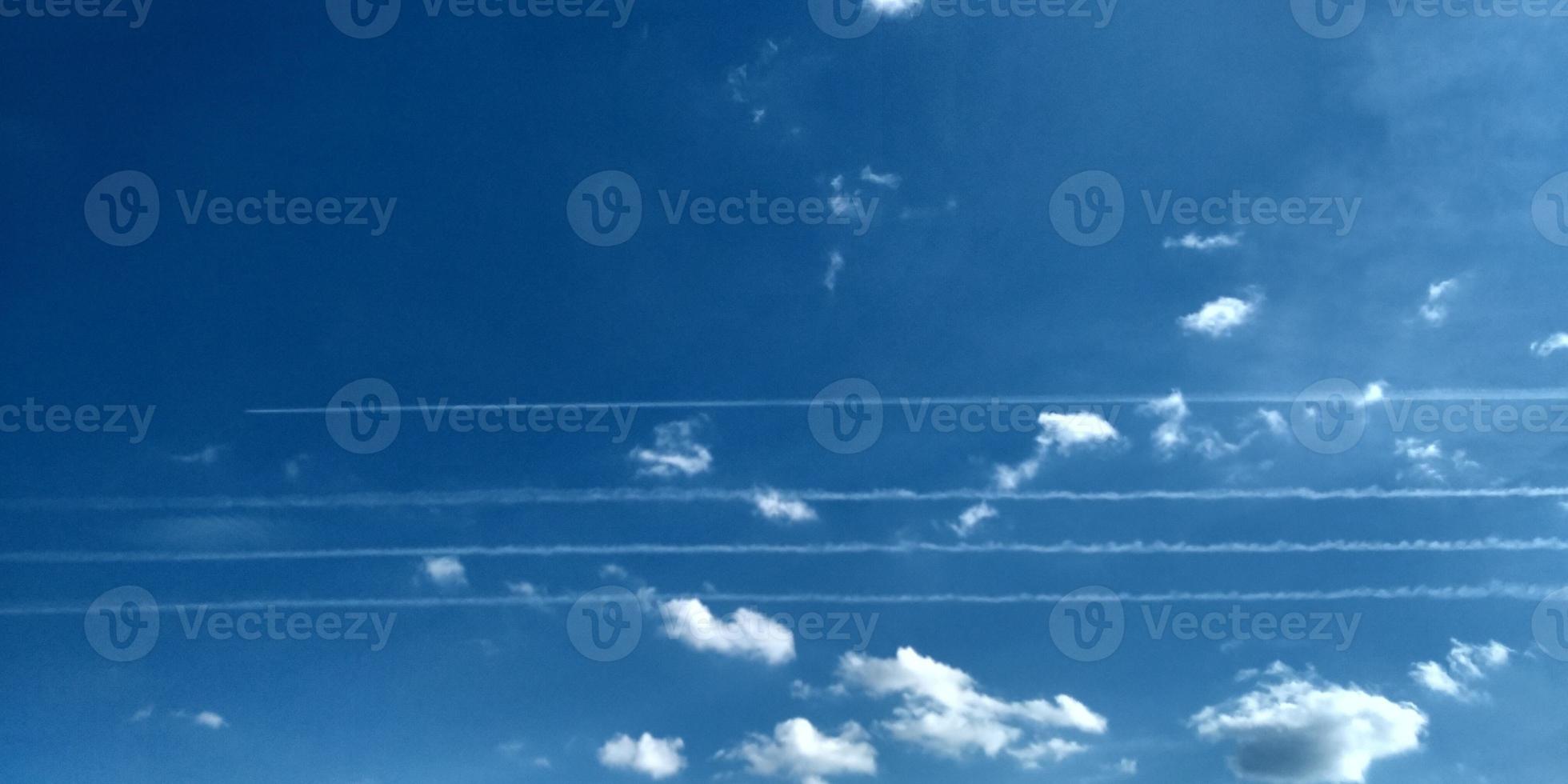 Trace from the plane in the air. Four planes traces. Sky clouds. Abstract blurred blue gradient of the spring sky. photo
