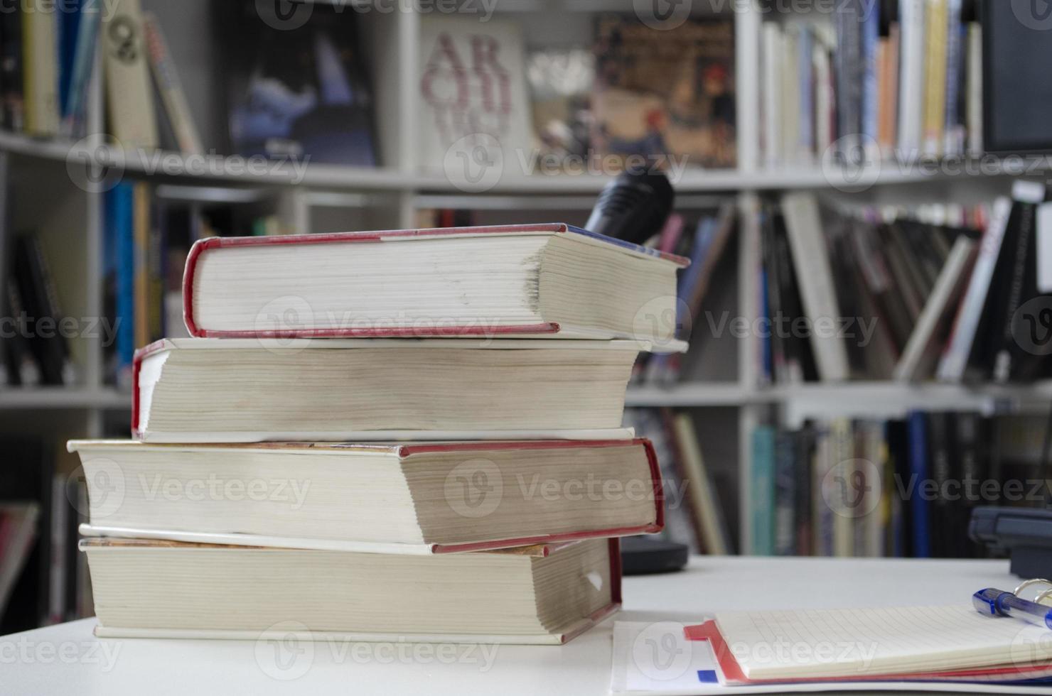 Old dirty books on the table. Books blurred background. photo