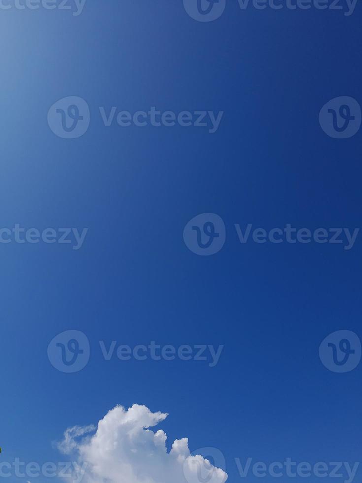 Beautiful white clouds on deep blue sky background. Large bright soft fluffy clouds are cover the entire blue sky. photo