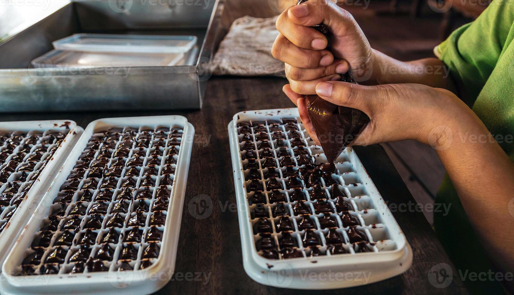 Close up of hand chef making homemade chocolate bars photo