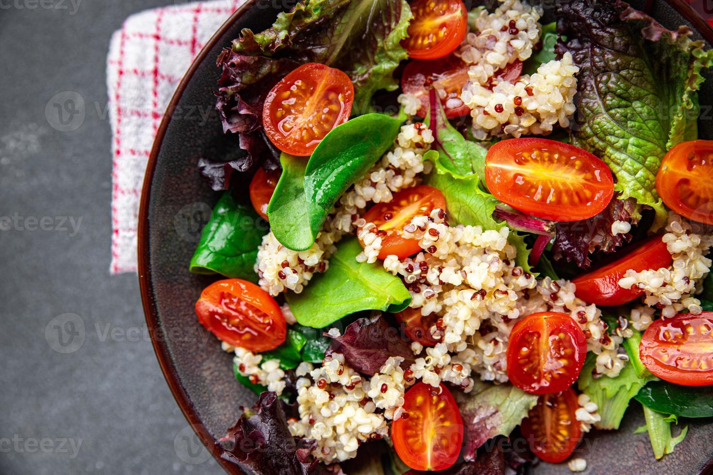 salad quinoa, tomato, green lettuce mix healthy meal food snack on the table copy space food background rustic top view photo