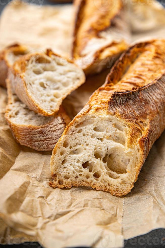 baguette long white bread whole wheat flour, wheat bread, sourdough meal food snack on the table copy space food background rustic top view photo