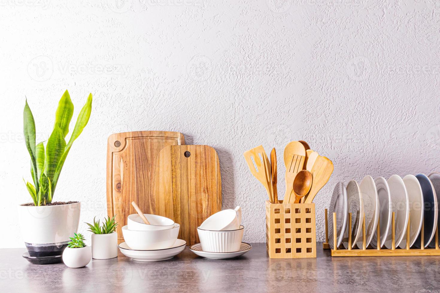 Beautiful kitchen background with a set of various environmentally friendly dishes, cutting boards, bowl. space for text. photo