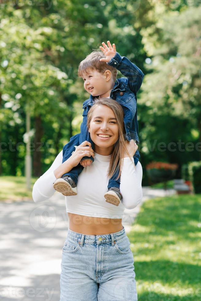 Young mother and son spend a joint weekend on holidays. the concept of a happy harmonious family outdoors. photo