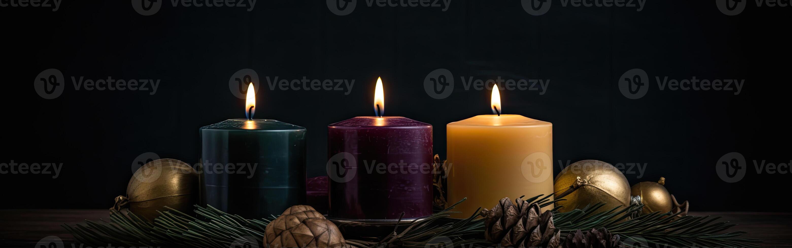Burning candle and Christmas decoration over snow and wooden background. . photo