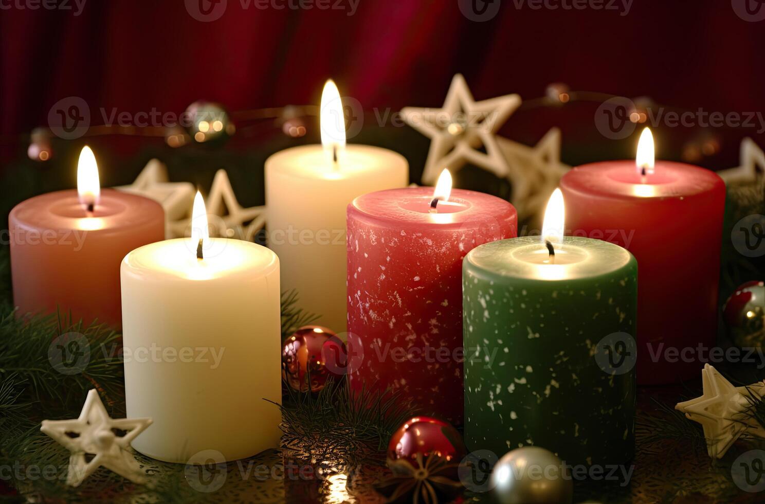 Burning candle and Christmas decoration over snow and wooden background. . photo