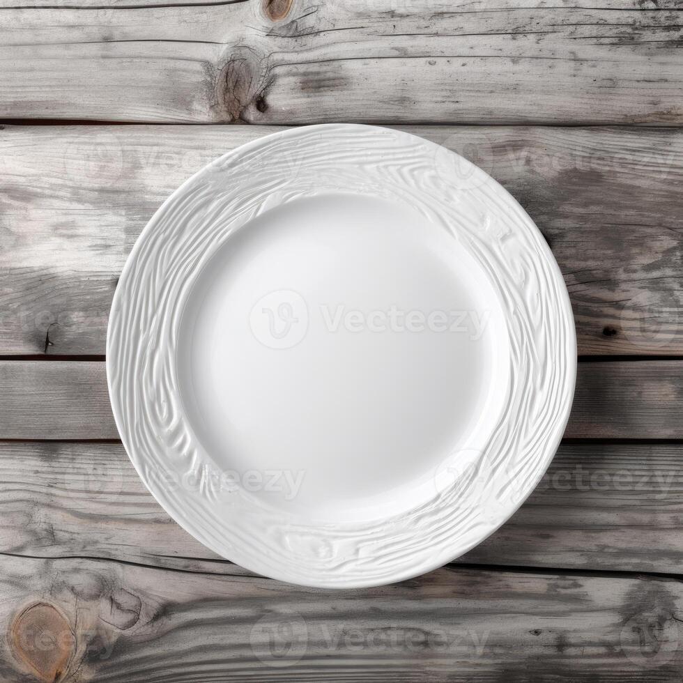 An empty plate on a white wooden table. Top view of white ceramic plate on white wooden. . photo