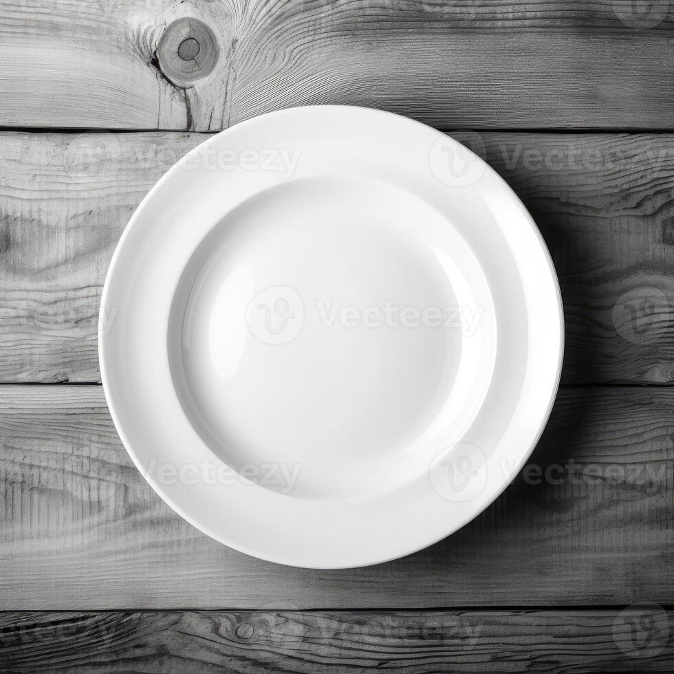 An empty plate on a white wooden table. Top view of white ceramic plate on white wooden. . photo