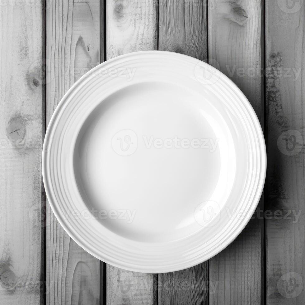 An empty plate on a white wooden table. Top view of white ceramic plate on white wooden. . photo