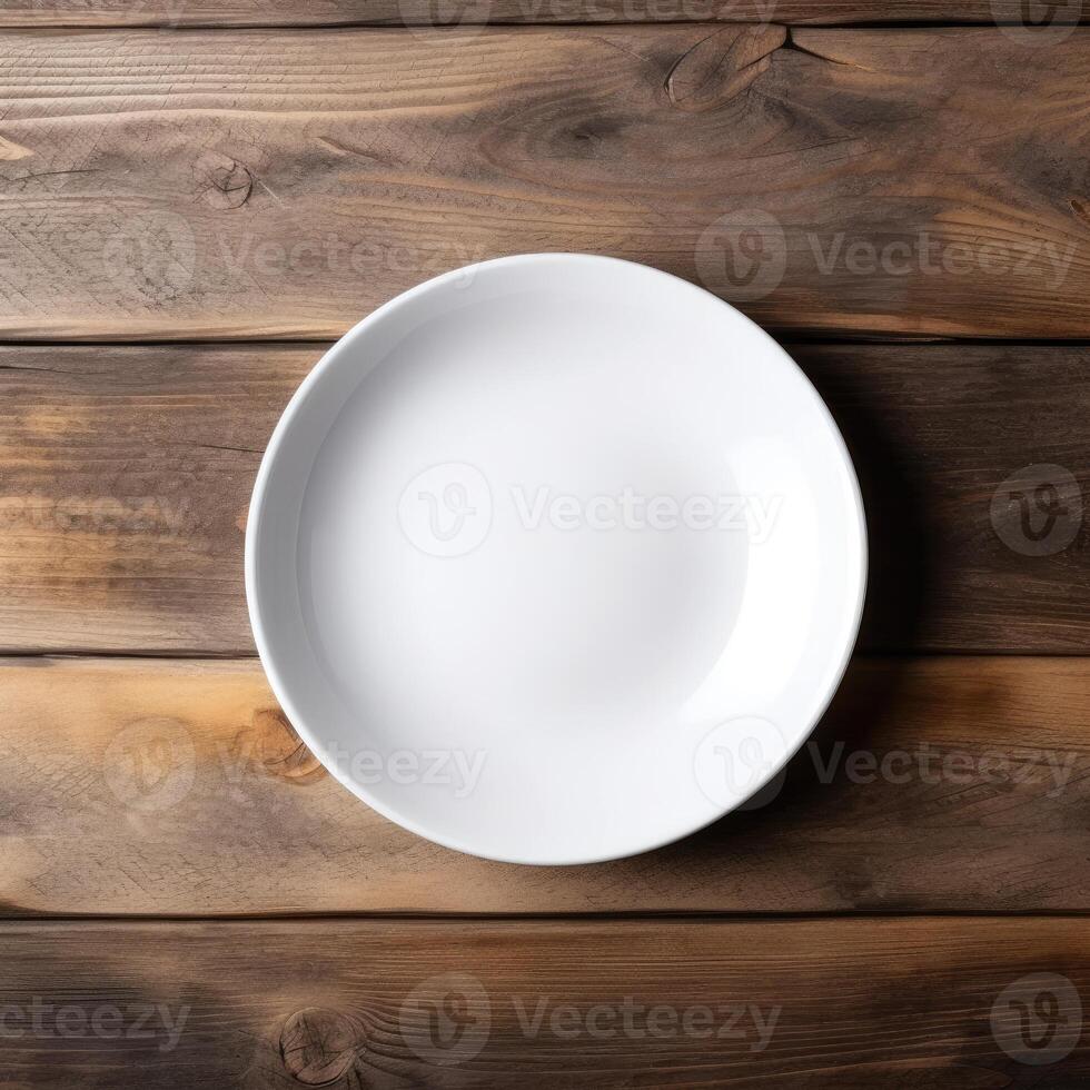 An empty plate on a white wooden table. Top view of white ceramic plate on white wooden. . photo