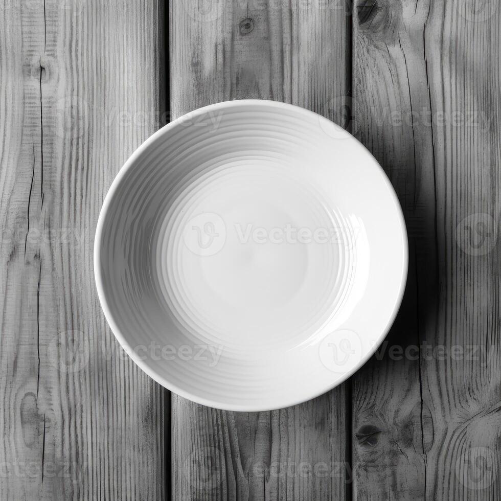 An empty plate on a white wooden table. Top view of white ceramic plate on white wooden. . photo