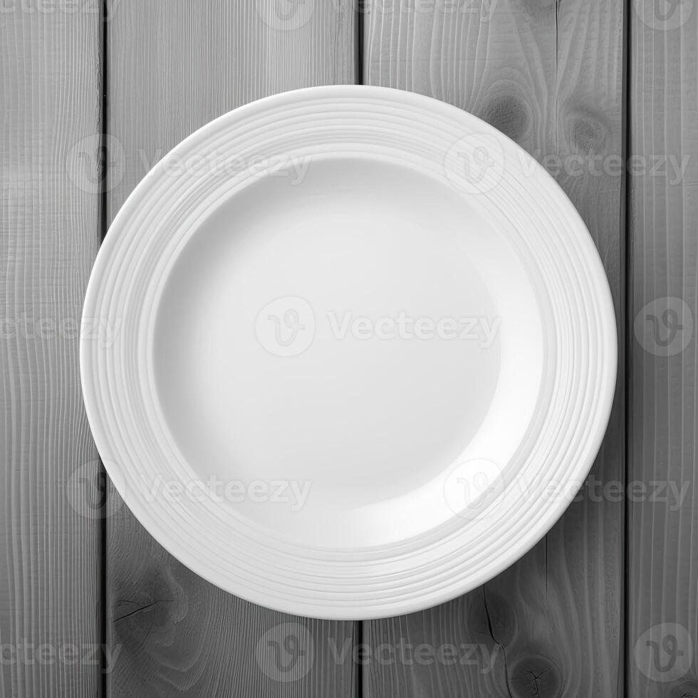 An empty plate on a white wooden table. Top view of white ceramic plate on white wooden. . photo