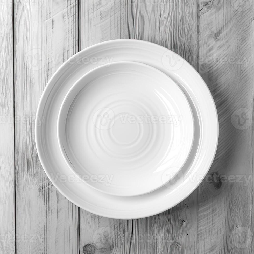 An empty plate on a white wooden table. Top view of white ceramic plate on white wooden. . photo