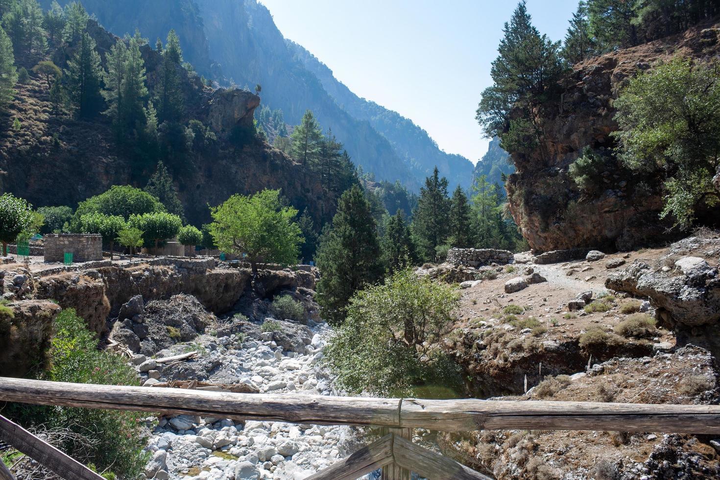 forest and mountain landscape, trails of travelers and mountains in the distance. Wooden bridges and streams photo