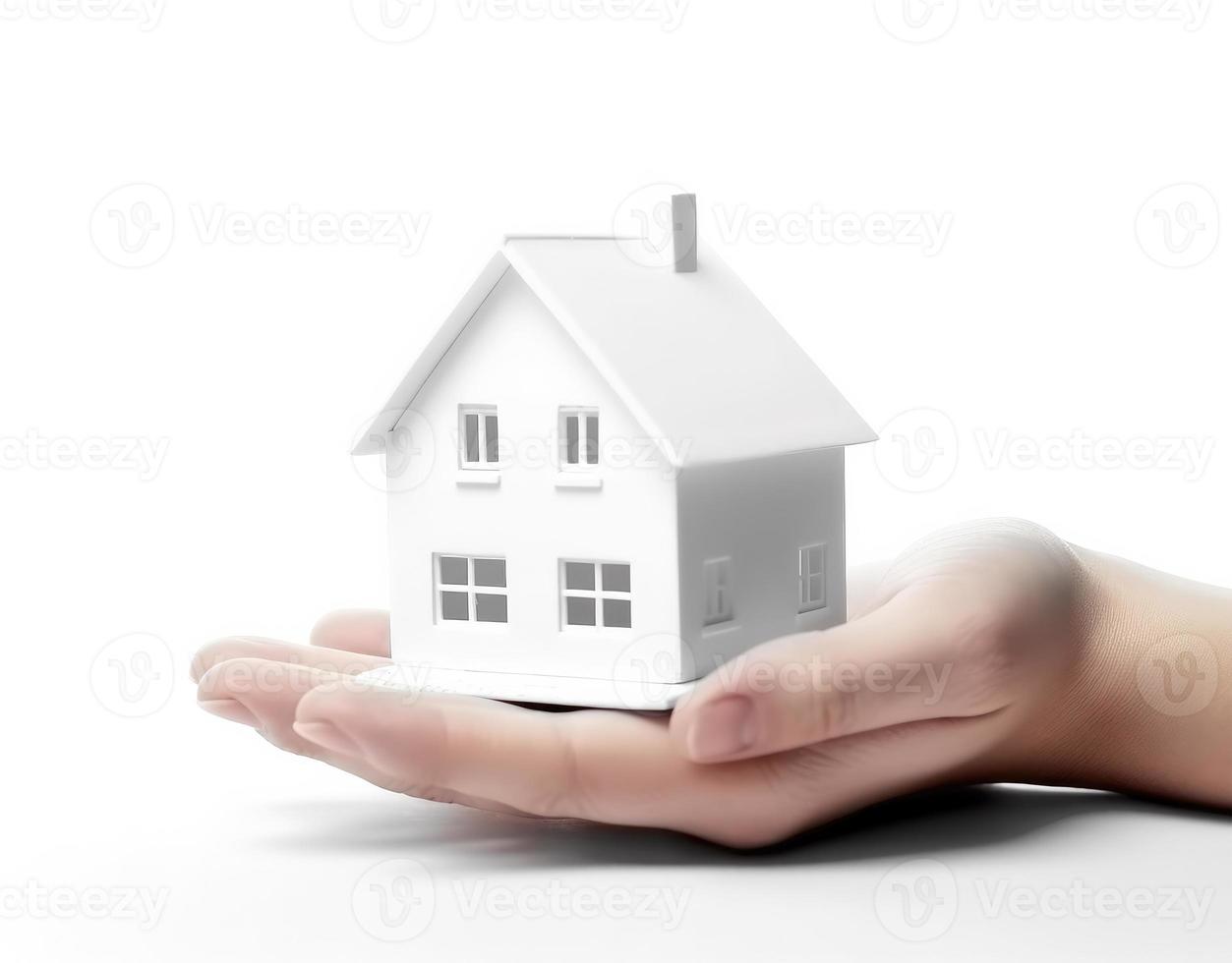 White house in hand isolated on a white background. Insurance concept. photo