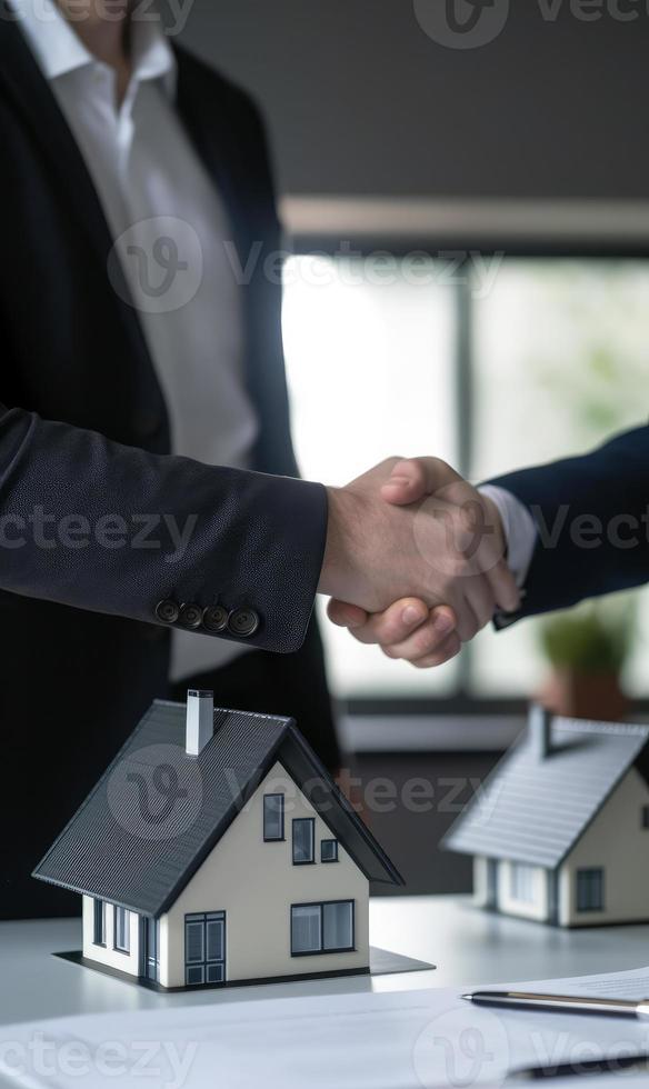 Real estate agent shaking hands with customer after signing contract for buying a house. photo