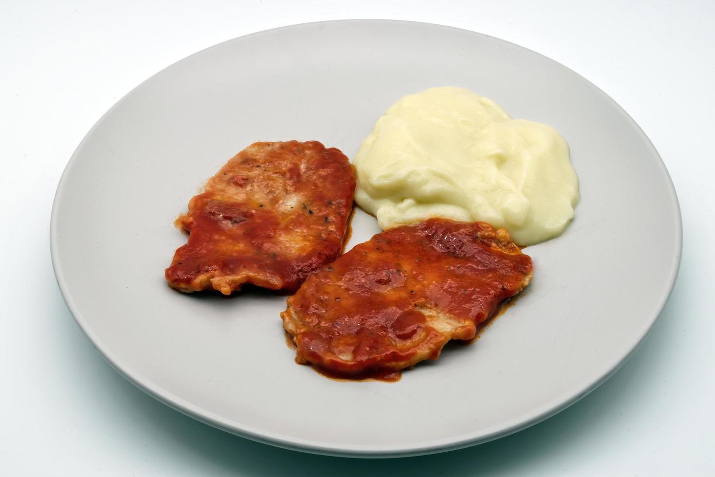 Escalopes with potatoes mash isolated on white background. photo