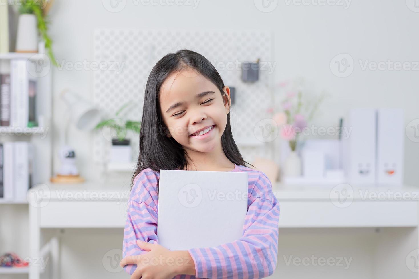 education and school concept - little student girl reading book photo