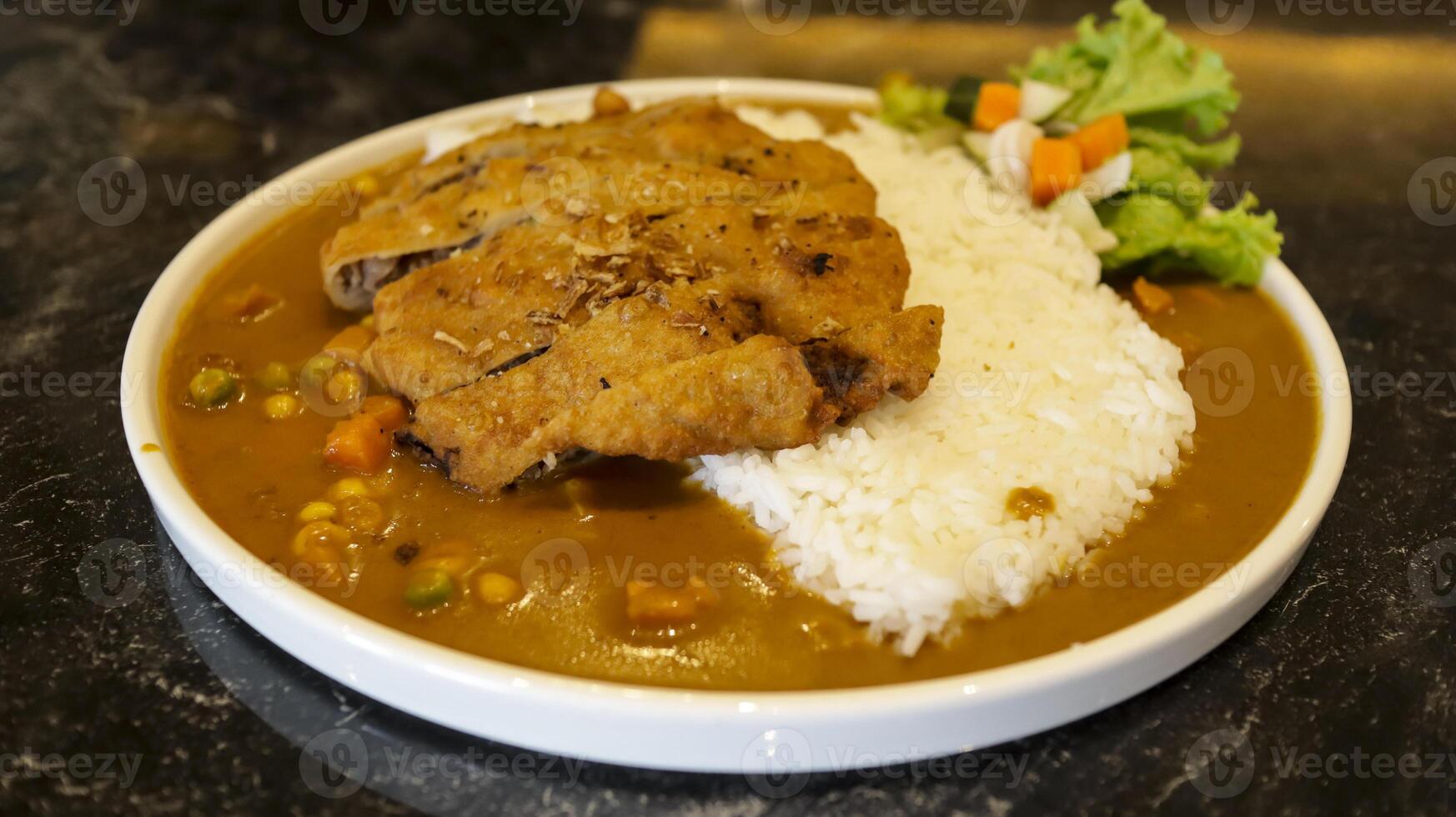 English chicken schnitzel curry with rice and good plating presentation. Thin slice of meat chicken breasts that is breaded and fried, popular dish in Germany. photo