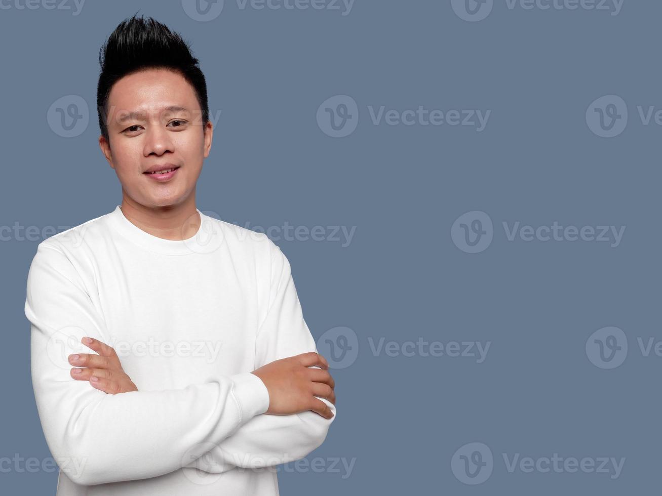 Handsome man wearing white sweater folding arms on body photo