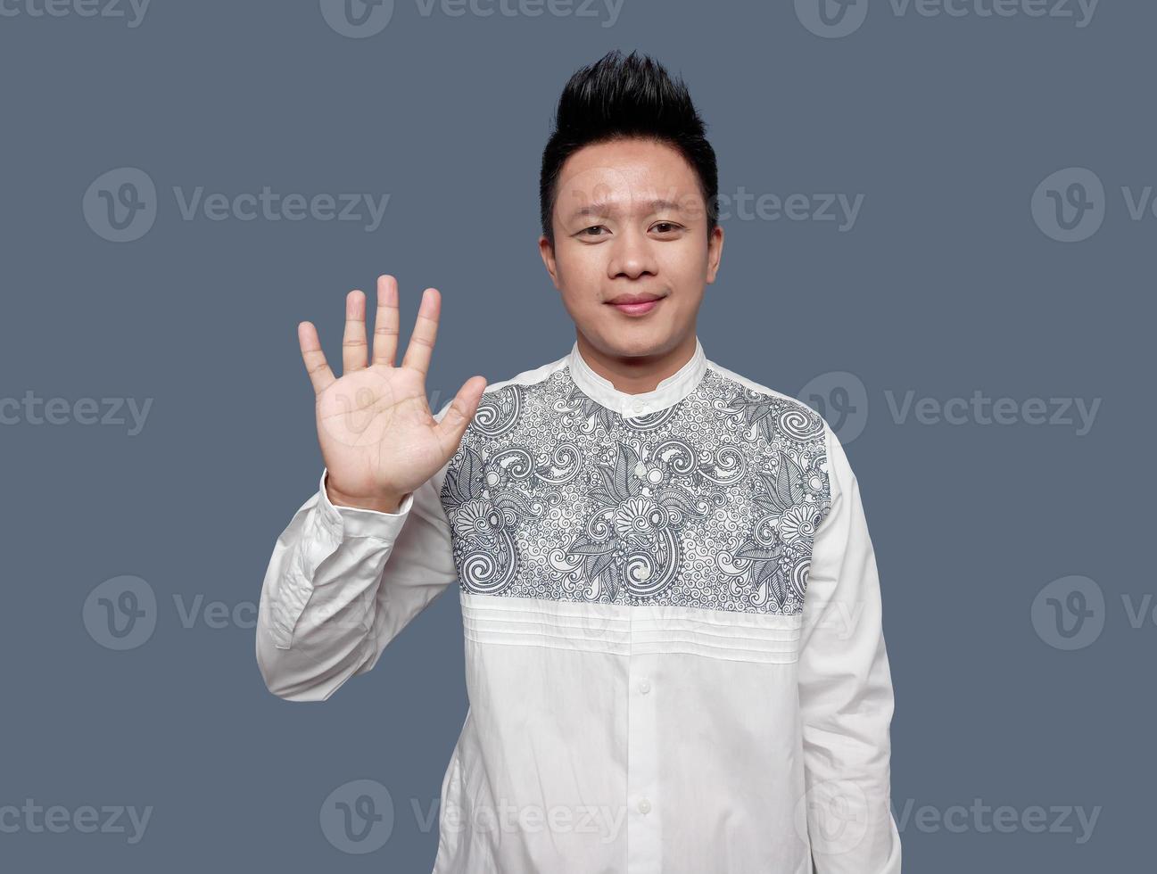 Handsome man with five hand gesture isolated on plain photo