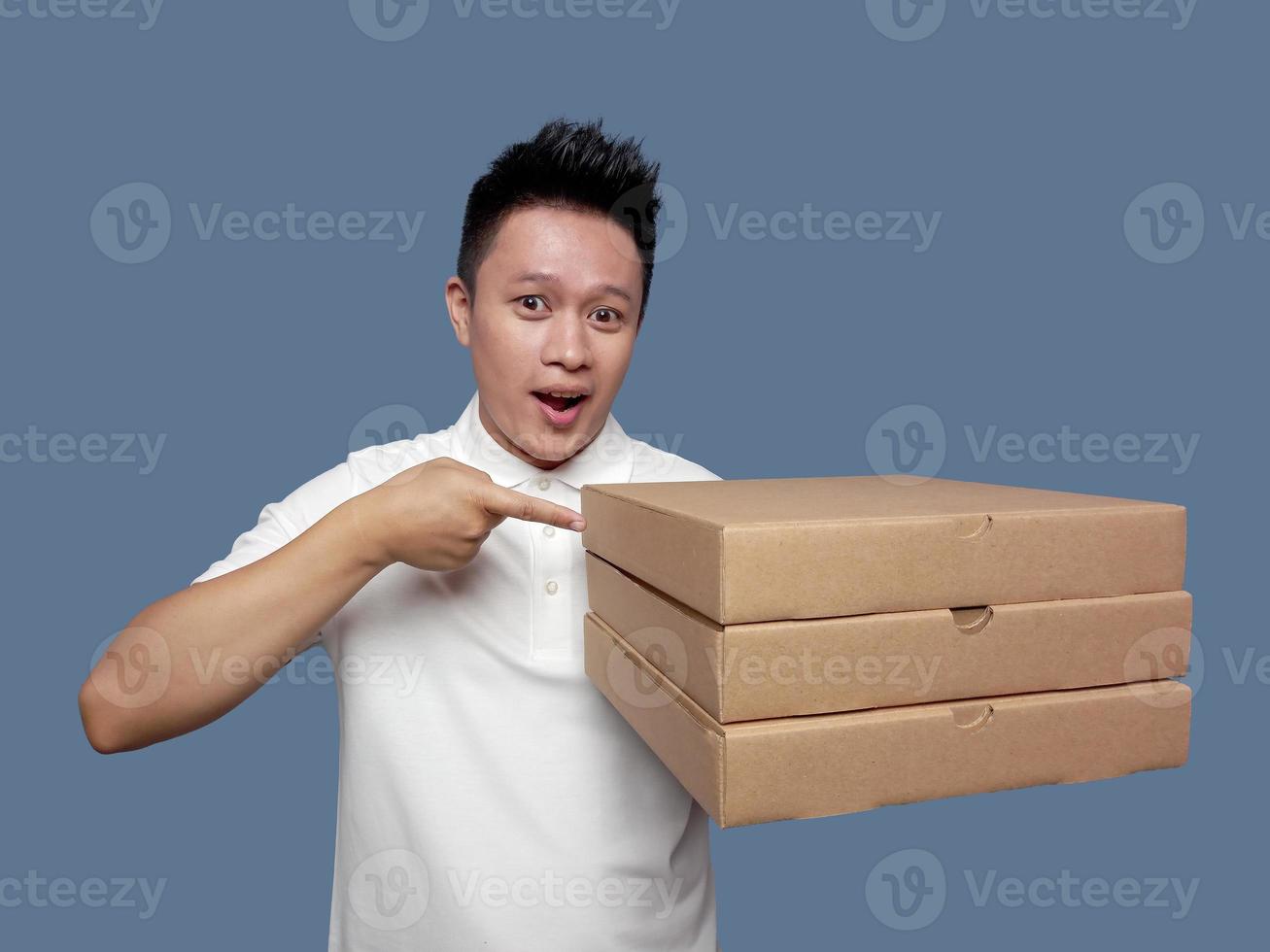 Man with shocked expression holding and pointing cardboard box photo