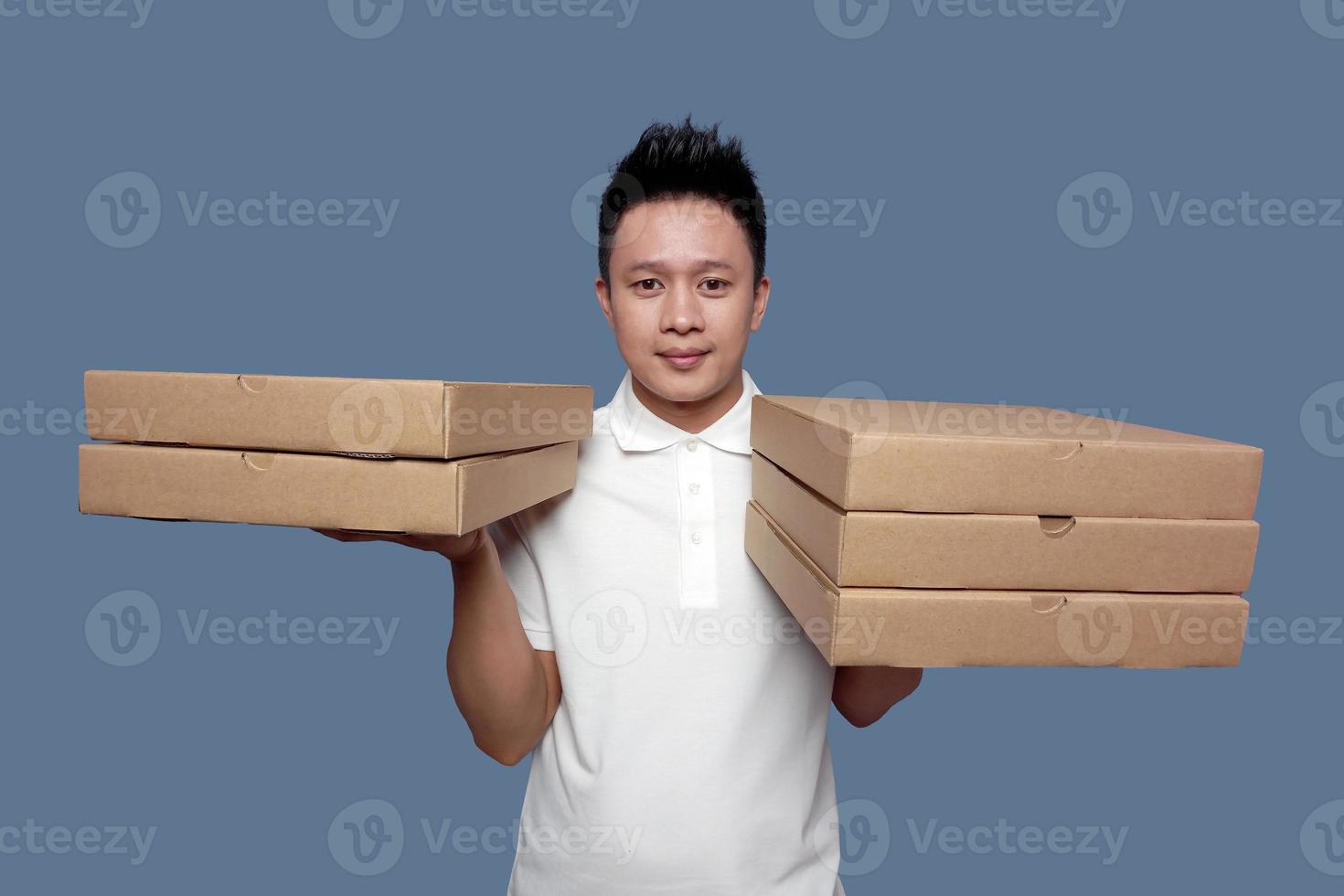 Man holding cardboard box in both hands isolated on plain background. photo