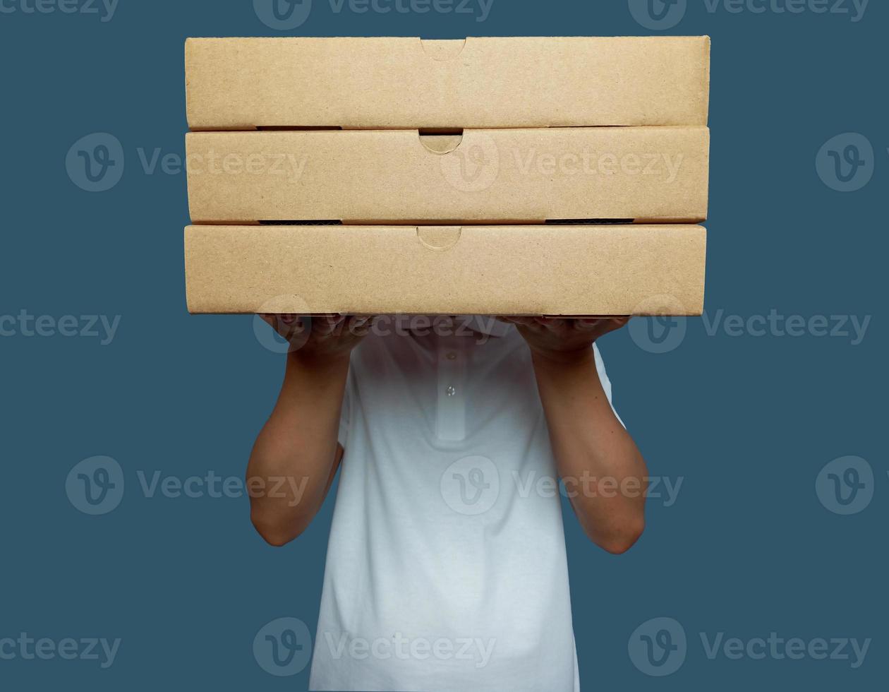 Man held up three brown cardboard boxes and covered his face photo