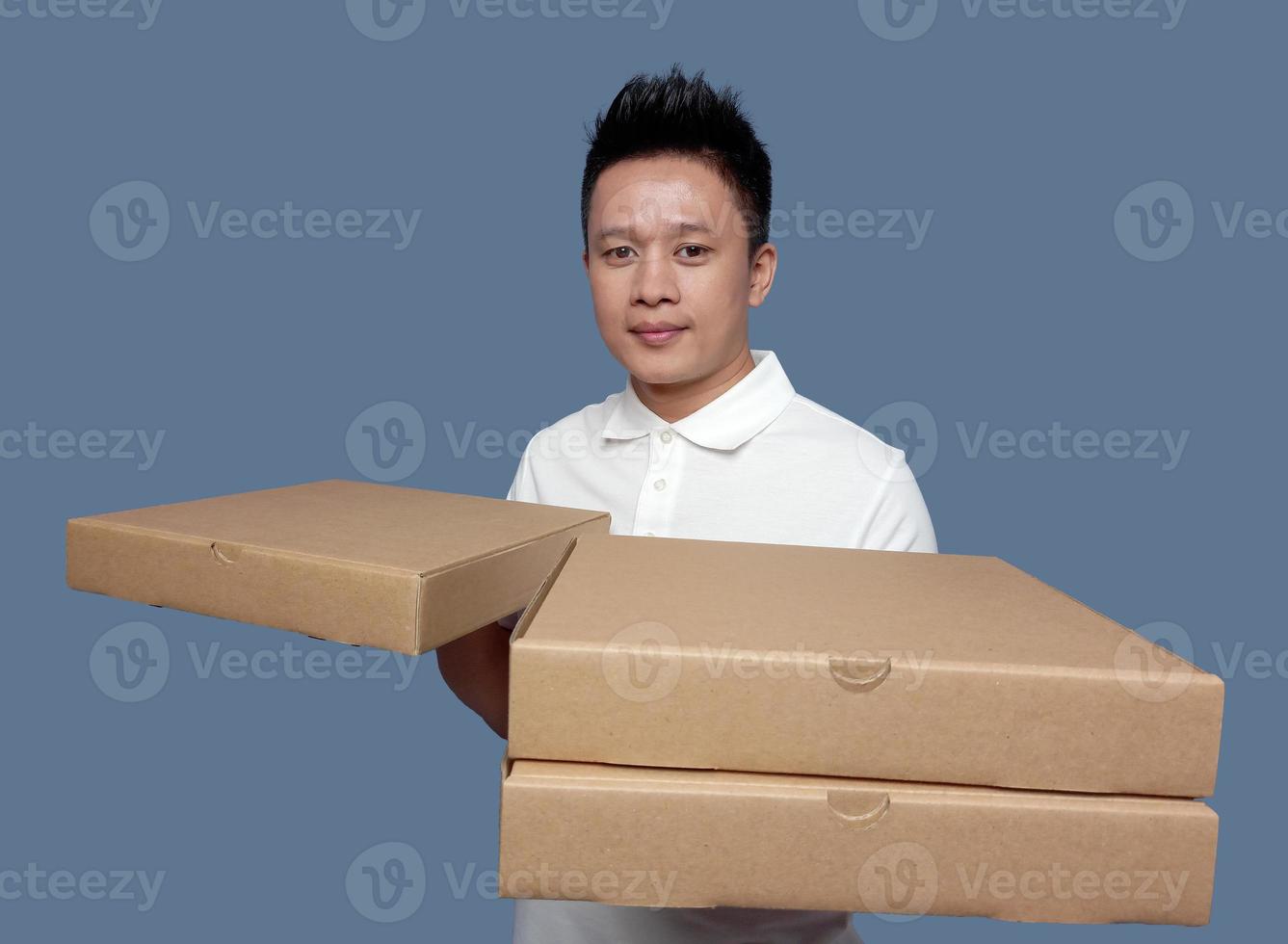 Man holding cardboard pizza box isolated on plain background. photo