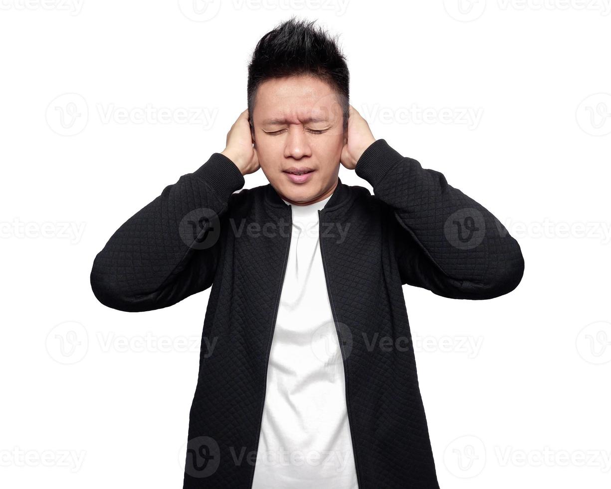 Man cover both ears while closing both eyes isolated on white photo